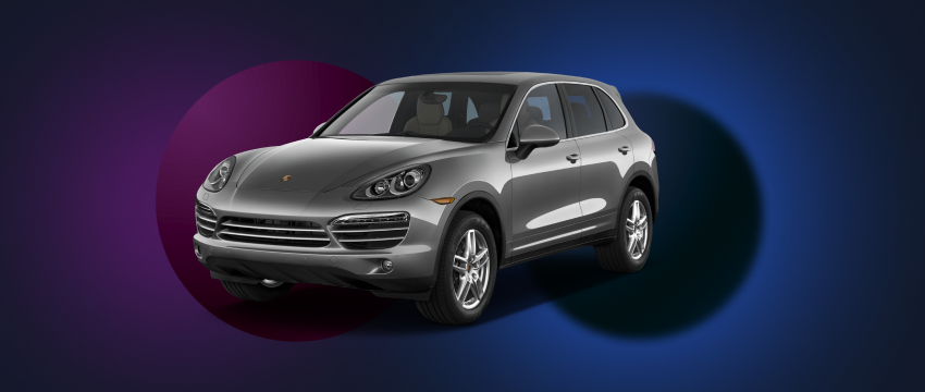 A sleek Porsche SUV stands out against a dark blue background, showcasing luxury and speed.